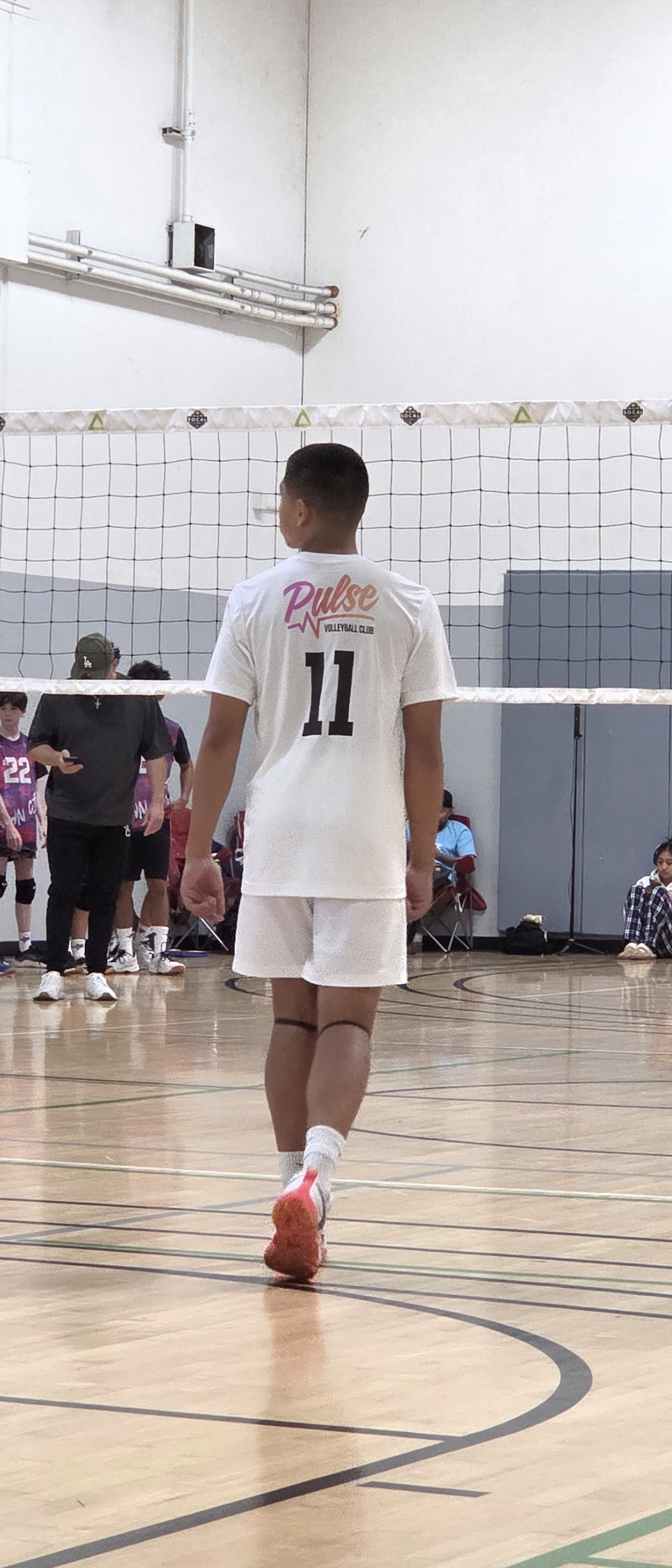 Josh Rathnam, #11, on court seen from behind